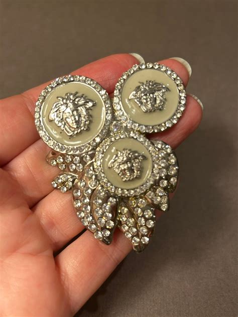 versace brooch.